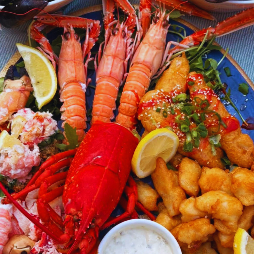 Mixed seafood platter with lobster, langoustines, crab meat and battered fish